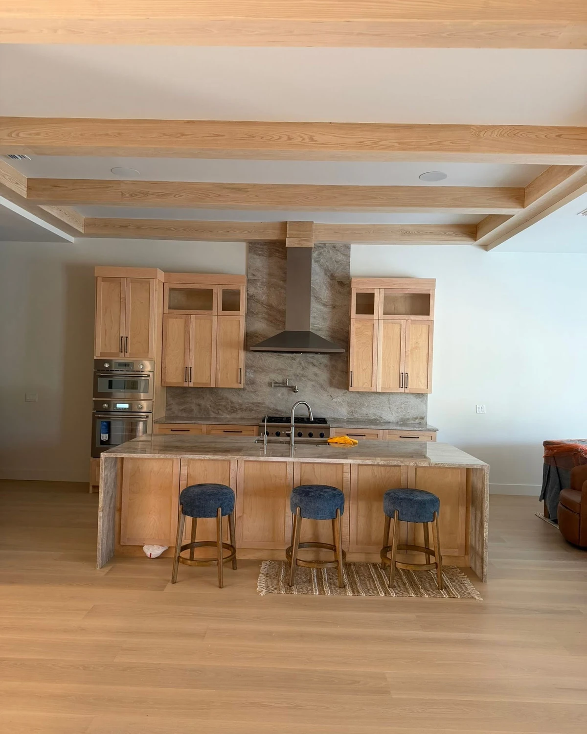 Finished natural-oak kitchen with custom cabinetry, island and ceiling beams in a Northeast Florida home