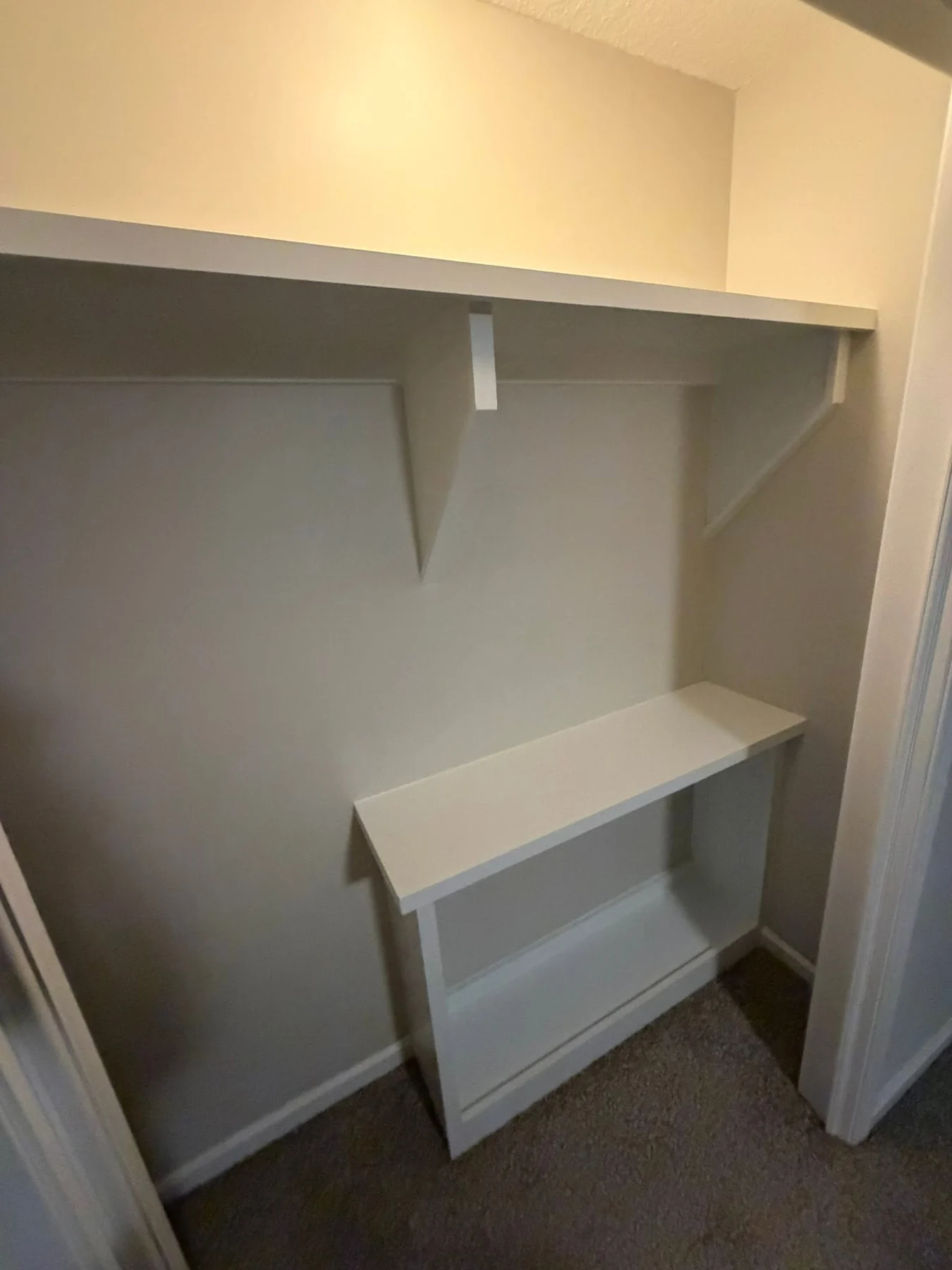 Compact custom closet with shelves, hanging space and a built-in bench